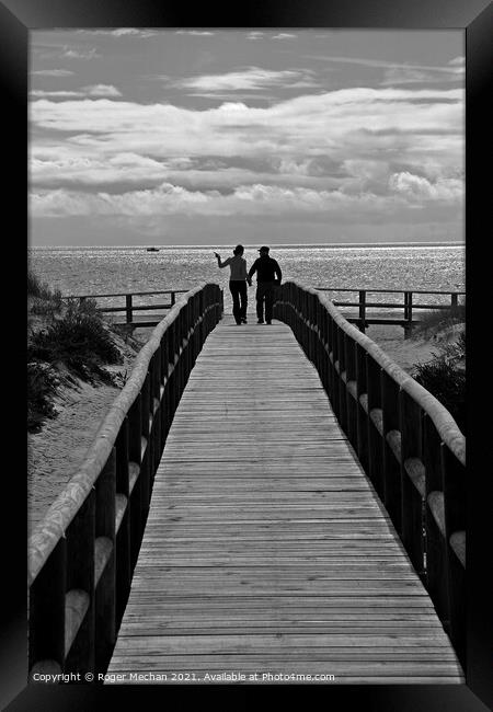Romance on a Boardwalk Framed Print by Roger Mechan