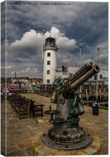 Scarborough Harbour Lighthouse and Gun Canvas Print by Ron Ella