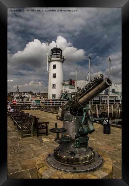 Scarborough Harbour Lighthouse and Gun Framed Print by Ron Ella