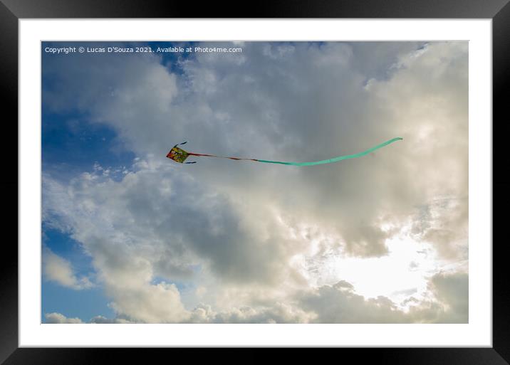 Kite flying against backdrop of beautiful clouds Framed Mounted Print by Lucas D'Souza