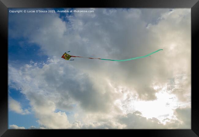 Kite flying against backdrop of beautiful clouds Framed Print by Lucas D'Souza