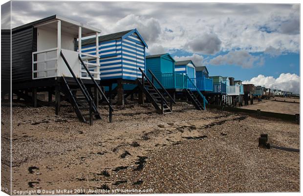 Beach huts at low tide Canvas Print by Doug McRae