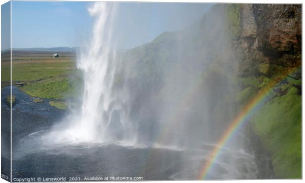 Rainbow in front of Seljalandsfoss waterfall in Iceland Canvas Print by Lensw0rld 
