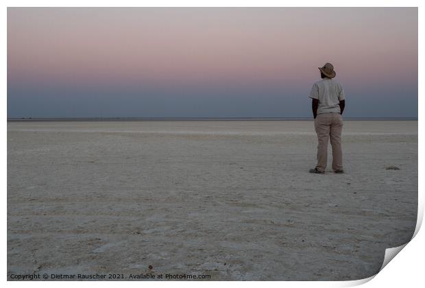 Dusk in Makgadikgadi Salt Pan - Black Man Gazing at Horizon Print by Dietmar Rauscher