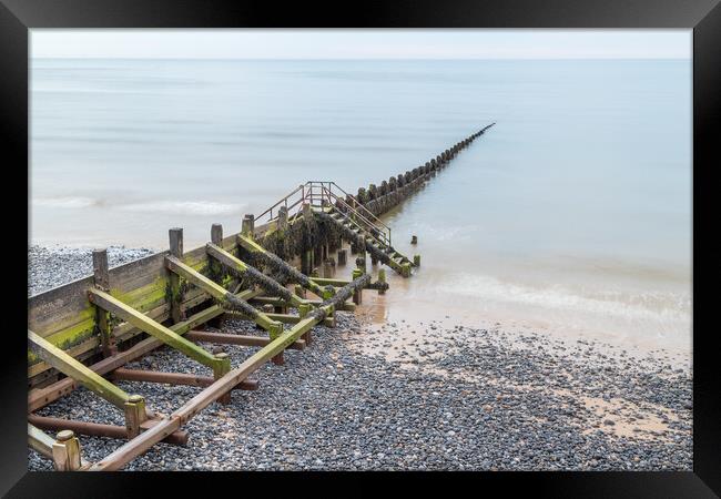 Wooden groyne stretching into the sea Framed Print by Jason Wells
