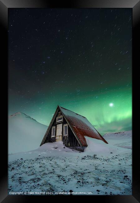 Snowy cabin and northern lights Framed Print by Giles Rocholl