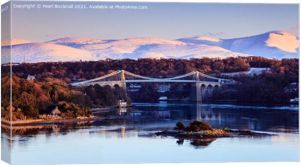 Menai Bridge and Snowdonia from Anglesey in Winter Canvas Print by Pearl Bucknall