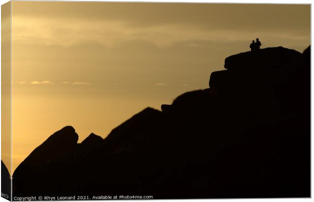 A couple stand silhouetted against a sunset atop stanage edge Canvas Print by Rhys Leonard