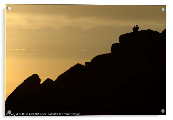 A couple stand silhouetted against a sunset atop stanage edge Acrylic by Rhys Leonard