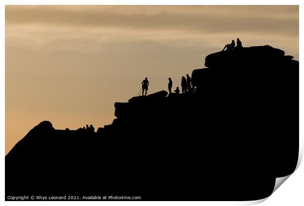 Silhouette of lots of people watching a climber at the summit of stanage edge. Climber wears a harness with tools like nuts, ropes and carabiners. Print by Rhys Leonard