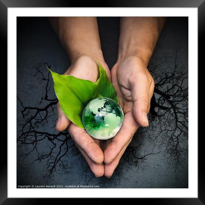 Human hands holding a green globe of planet Earth on green leave Framed Mounted Print by Laurent Renault