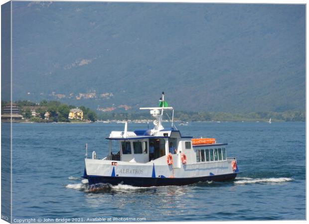 A  Ferry on Lake Maggiore Canvas Print by John Bridge
