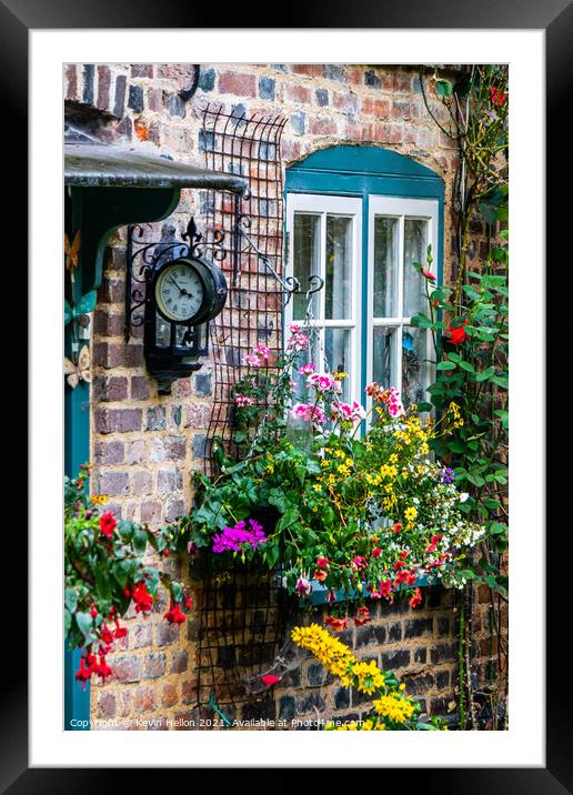Flowers and a clock outside an English country cottage  Framed Mounted Print by Kevin Hellon
