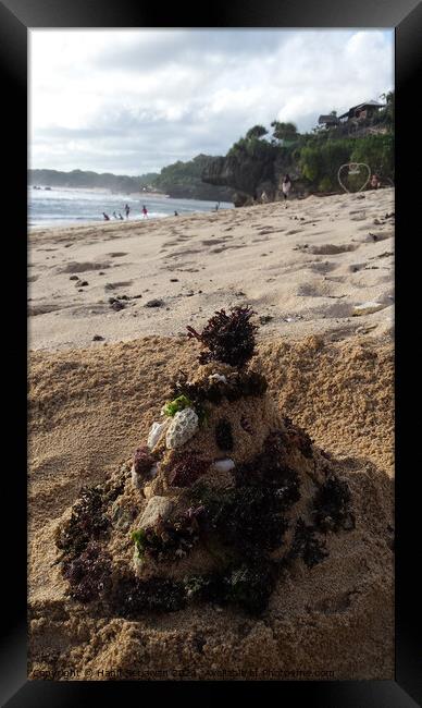 Santa Claus built from sand seaweed and stones at a sand beach 2a Framed Print by Hanif Setiawan