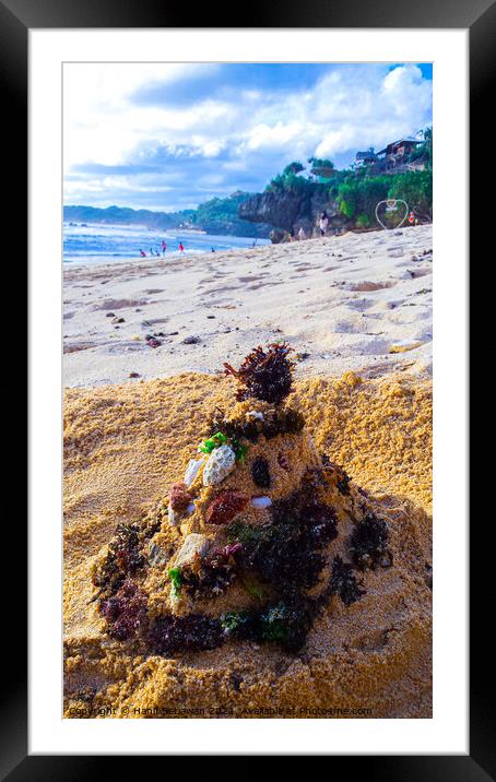 Santa Claus built from sand seaweed and stones at a sand beach 2b Framed Mounted Print by Hanif Setiawan