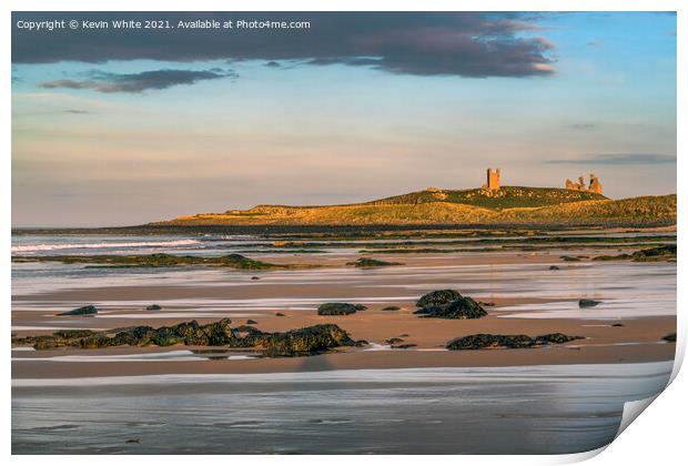 Sunsetting over Dunstanburgh castle on Embleton beach Print by Kevin White
