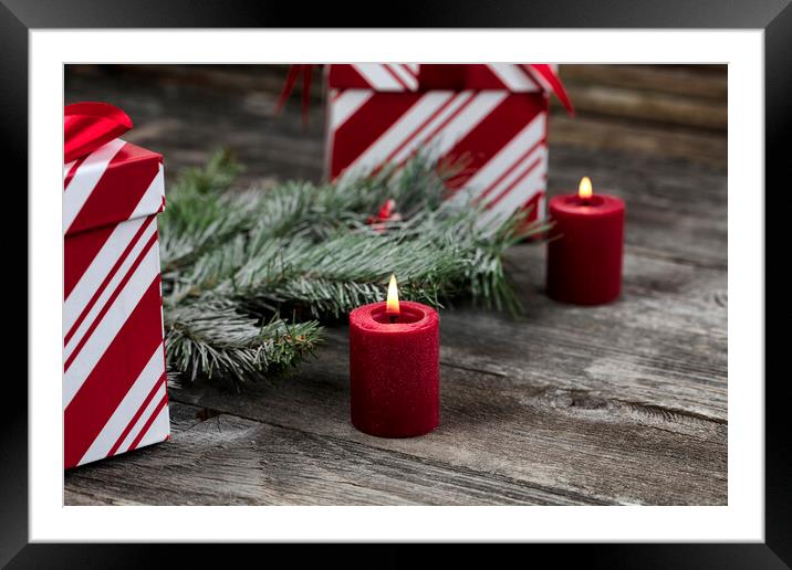 Burning red candle with decorations in background for a merry Ch Framed Mounted Print by Thomas Baker