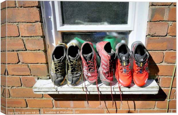 Running trainers out to dry. Canvas Print by john hill