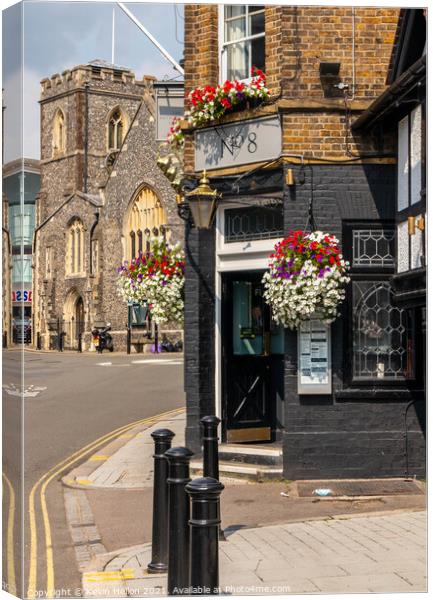 Entrance to the Metropolitan Tavern with St Margaret's church in Canvas Print by Kevin Hellon