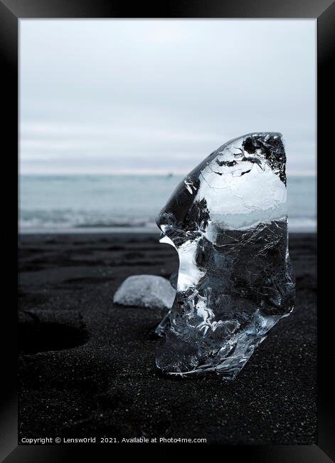 Clear piece of glacial ice on black sand Framed Print by Lensw0rld 