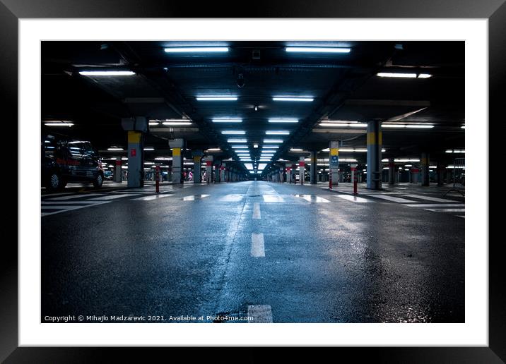 Neon lighted reflective garage Framed Mounted Print by Mihajlo Madzarevic