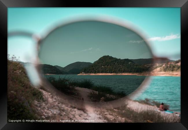 Focus view of mountain nature and a lake through s Framed Print by Mihajlo Madzarevic