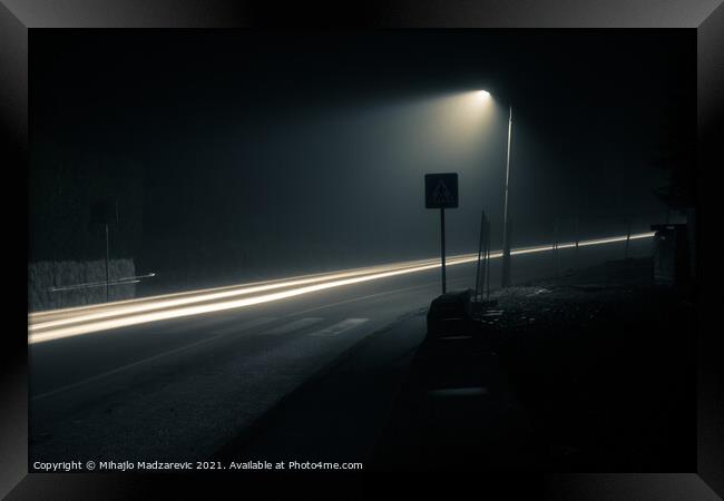 Dark foggy city street at night with a light trail Framed Print by Mihajlo Madzarevic