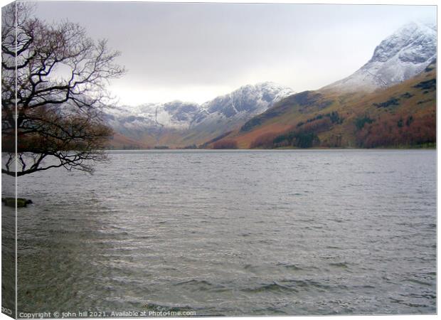 Snow Capped mountains at Buttermere Lake Canvas Print by john hill