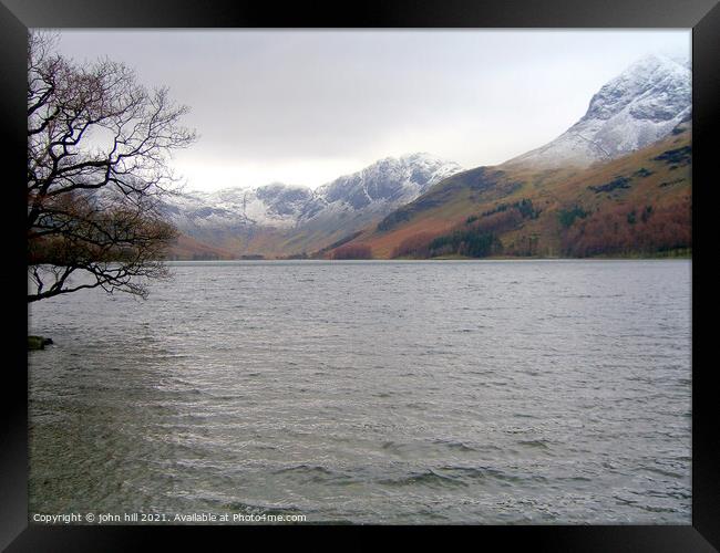 Snow Capped mountains at Buttermere Lake Framed Print by john hill