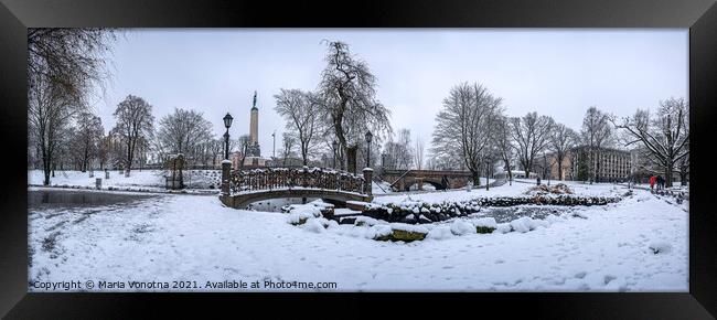 Snowy park with footbridge in winter Framed Print by Maria Vonotna