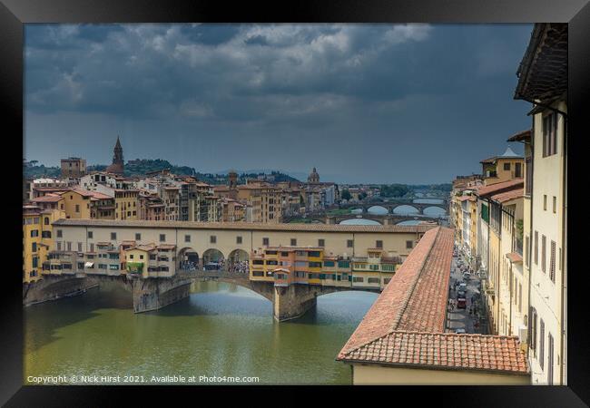 Ponte Vecchio under a Stormy Sky Framed Print by Nick Hirst