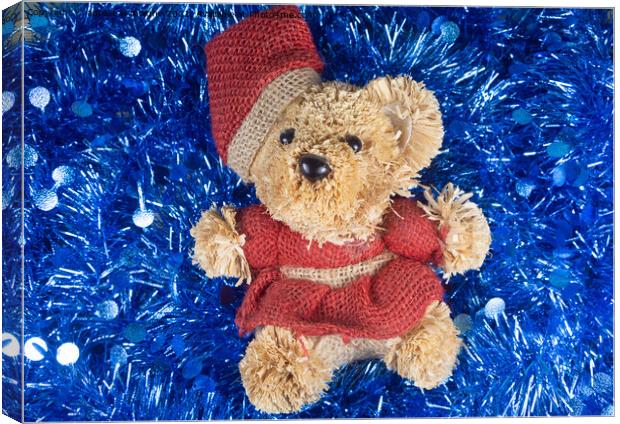 Teddy bear on blue tinsel Canvas Print by aurélie le moigne