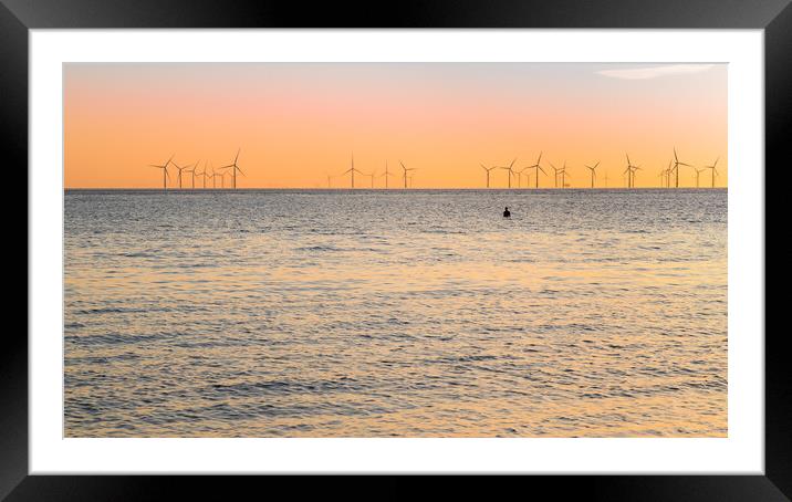 Iron Man watches the sunset at high tide Framed Mounted Print by Jason Wells