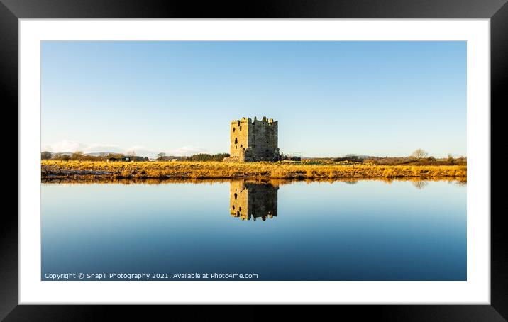 Threave Castle reflecting on the River Dee in the winter sun and ground frost Framed Mounted Print by SnapT Photography