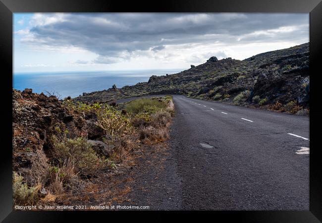 Empty road in a volcanic landscape in the Island of La Palma Framed Print by Juan Jimenez