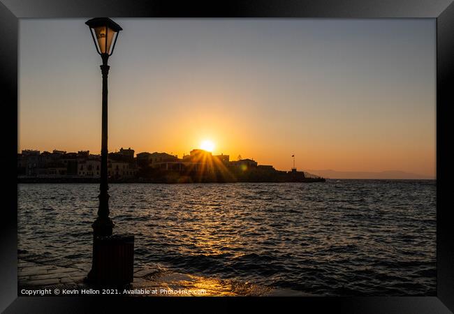 Sun setting over the Venetian Harbour, Chania Framed Print by Kevin Hellon