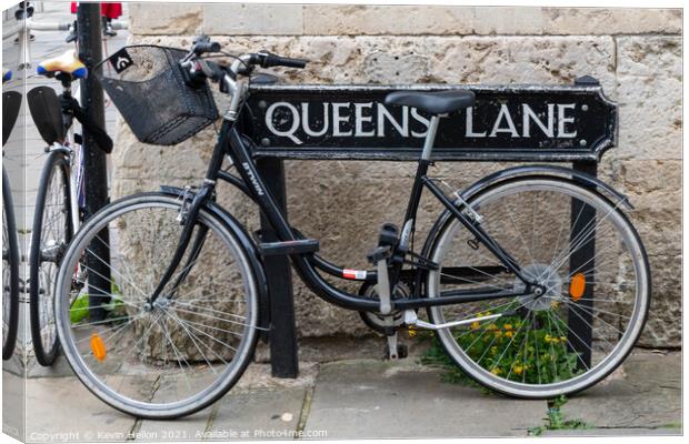 Bicycle locked to the street sign for Queen's Lane, Oxford, Canvas Print by Kevin Hellon