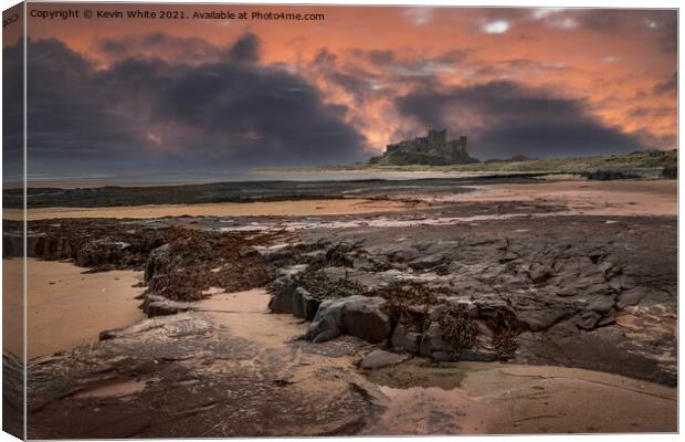 Bamburgh Castle dramatic sunset Canvas Print by Kevin White