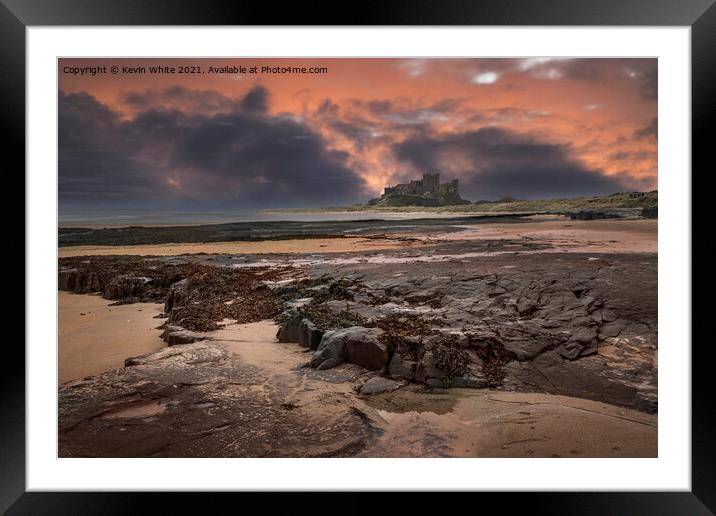 Bamburgh Castle dramatic sunset Framed Mounted Print by Kevin White