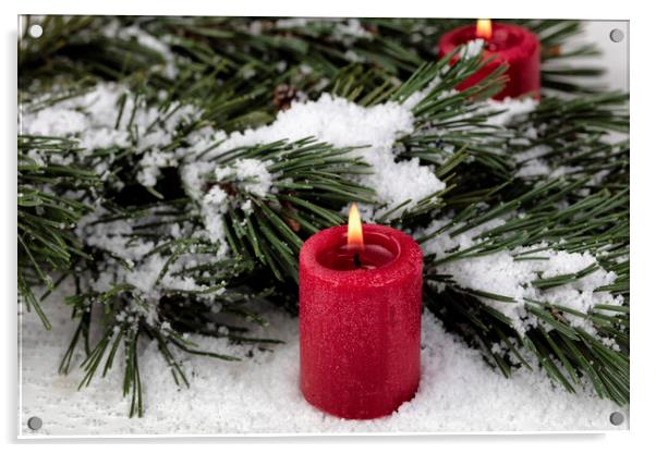 Close up view of a glowing red candle with snow covered fir tree Acrylic by Thomas Baker