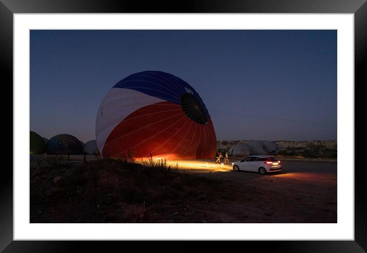 A car parked in front of a hot air balloon with headlights on during night, preparation of a flight in Goreme national park in Cappadocia, Turkey Framed Mounted Print by Arpan Bhatia