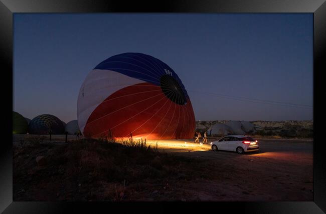 A car parked in front of a hot air balloon with headlights on during night, preparation of a flight in Goreme national park in Cappadocia, Turkey Framed Print by Arpan Bhatia