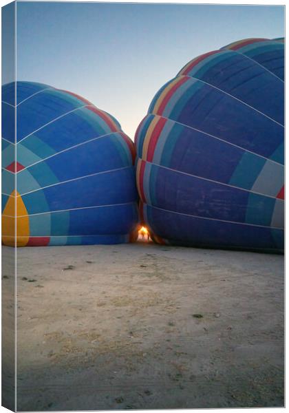Coloful air hot air balloons facing each other being filled with helium gas during night, preparation of a flight in Goreme national park in Cappadocia, Turkey Canvas Print by Arpan Bhatia