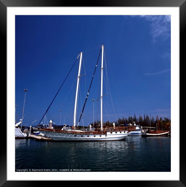 Saing boat at anchor Framed Mounted Print by Raymond Evans