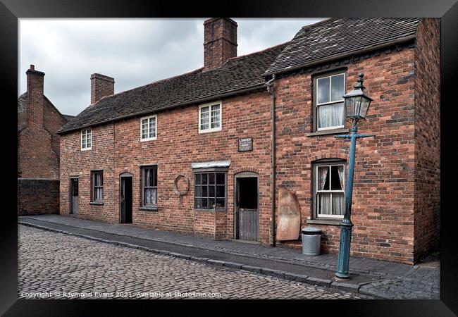 Brick terraced housing Framed Print by Raymond Evans