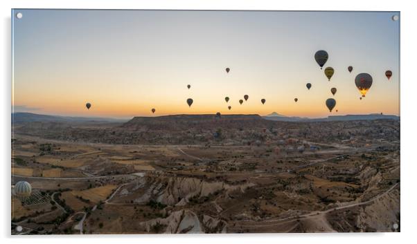 Cappadocia, Turkey - September 14, 2021: Wide angle Panorama aerial shot of colorful hot air balloons together floating in the sky at early morning in Goreme against volcanic hills Acrylic by Arpan Bhatia