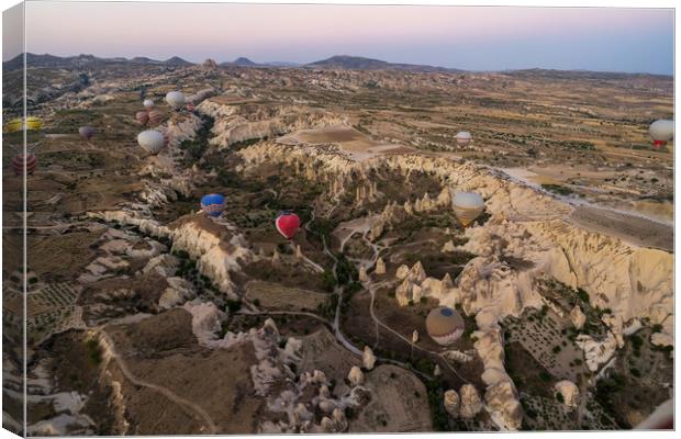 Many colorful hot air balloons flight above mountains and rocky formation - panorama of Cappadocia at sunrise. Wide landscape of Goreme valley - billboard background for your travel concept in Turkey Canvas Print by Arpan Bhatia