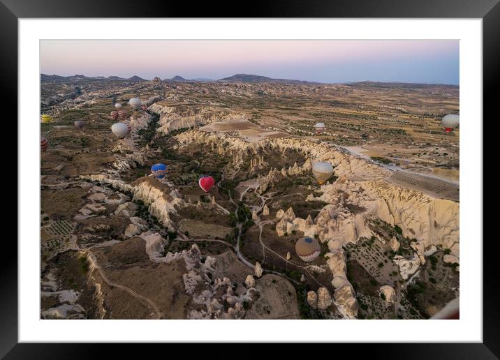 Many colorful hot air balloons flight above mountains and rocky formation - panorama of Cappadocia at sunrise. Wide landscape of Goreme valley - billboard background for your travel concept in Turkey Framed Mounted Print by Arpan Bhatia