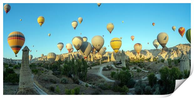 Panorama of bunch of colorful hot air balloon flying early morning in Cappadocia, Turkey against typical rock formation due to volcanic activity in love valley located in Goreme national park Print by Arpan Bhatia