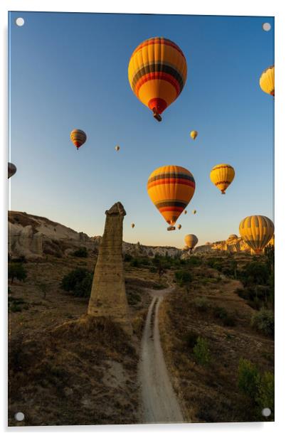 Vertical image of bunch of colorful hot air balloon flying early morning in Cappadocia, Turkey against typical rock formation due to volcanic activity in love valley located in Goreme national park Acrylic by Arpan Bhatia